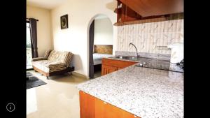 a kitchen with a sink and a couch in a room at Junior apartment in Pattaya