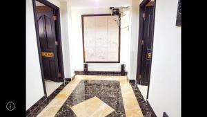 a hallway with two doors and a tile floor at Junior apartment in Pattaya