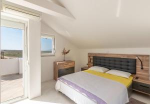 a bedroom with a large bed and a balcony at House Dali in Ražanac +42 photos