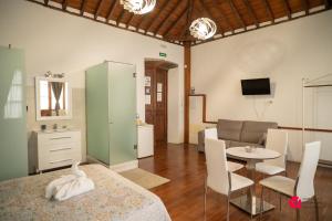 a living room with a bed and a table and a couch at ALOJAMIENTOS NECANA in Icod de los Vinos