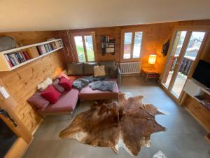 an overhead view of a living room with a large tree stumpimateimate at Chalet Safran in Grächen