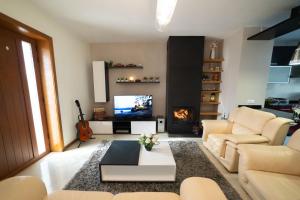 a living room with a couch and a fireplace at Casa do Casal do Douro in Marco de Canavezes