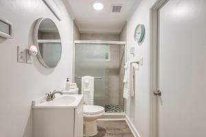 a white bathroom with a toilet and a shower at Family-Friendly Knoxville Home Close to UT! in Knoxville +23 photos