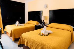 Postel nebo postele na pokoji v ubytování Hotel Antillano