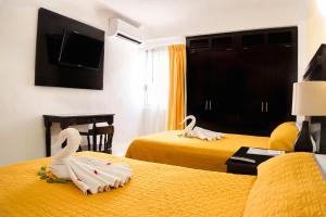 Postel nebo postele na pokoji v ubytování Hotel Antillano