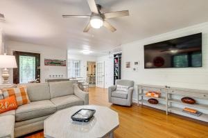 a living room with a couch and a ceiling fan at Family-Friendly Knoxville Home Close to UT! in Knoxville