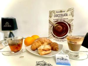 a table with two cups of tea and a plate of croissants at All'Arco Casa Vacanza in Acerenza