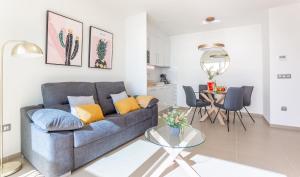 a living room with a couch and a table at Intempo by Holuxe - 292 -29th floor in Benidorm