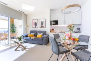 a living room with a table and a couch at Intempo by Holuxe - 292 -29th floor in Benidorm