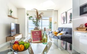 a living room with a table with a bowl of fruit at Intempo by Holuxe - 292 -29th floor in Benidorm +29 photos