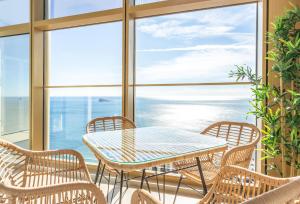 a table and chairs on a balcony with a view of the ocean at Intempo by Holuxe - 292 -29th floor in Benidorm