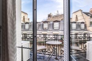 balkon ze stołem i widokiem na miasto w obiekcie Appartement Champs Elysées w Paryżu