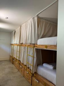 two bunk beds in a room with white curtains at Surf & Sea Suites in Parede