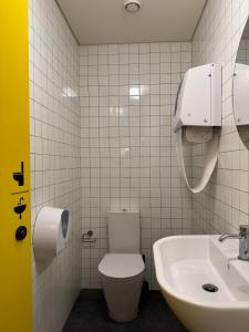 a bathroom with a toilet and a sink at Surf & Sea Suites in Parede
