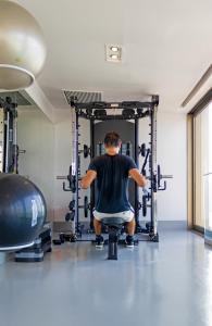 a man sitting in a chair in a gym at PortoBay Rio de Janeiro in Rio de Janeiro