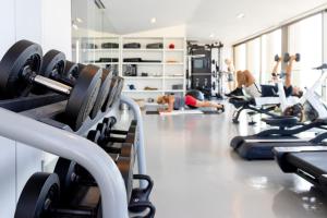 a gym with several people exercising in machines at PortoBay Rio de Janeiro in Rio de Janeiro