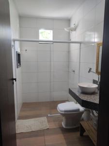 a bathroom with a toilet and a sink at Casa Viva Guaibim in Guaibim +18 photos
