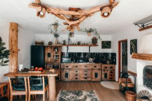 a kitchen with wooden cabinets and a table at Hobbit House - Arieseni in Arieşeni