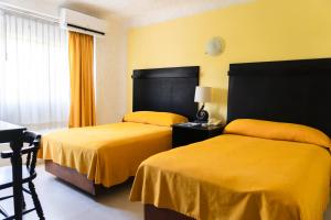 Postel nebo postele na pokoji v ubytování Hotel Antillano