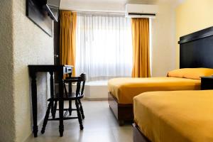 Postel nebo postele na pokoji v ubytování Hotel Antillano