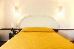 Postel nebo postele na pokoji v ubytování Hotel Antillano