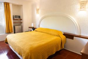 Postel nebo postele na pokoji v ubytování Hotel Antillano