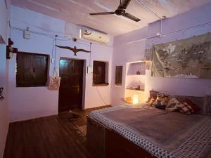 焦特布尔Tiny Home Jodhpur - A studio apartment的带床和吊扇的卧室