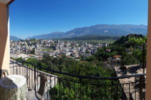 a view of a city from a balcony at Simos Apartment in Gjirokastër