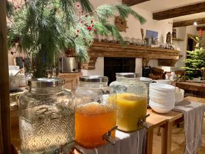 three glass jars filled with drinks on a table at Victoria Retreat & Spa in Vercorin