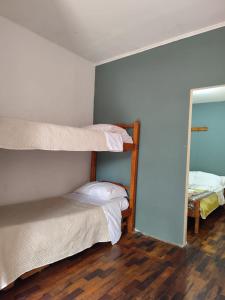 two bunk beds in a room with a mirror at Daymán Apart Hotel in Termas del Daymán