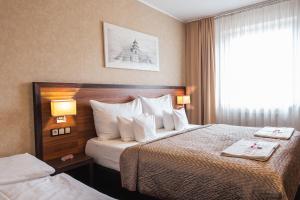 Postel nebo postele na pokoji v ubytování PREMIUM Business Hotel Bratislava + 37 fotografií