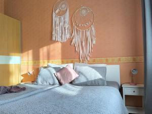 a bedroom with a bed with blue and pink pillows at Flip-Flops Apartment Jurmala with free parking in Jūrmala