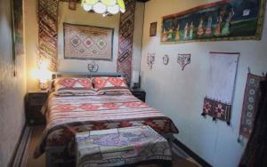 a bedroom with a bed and some pictures on the wall at La Loma del Chivo Llc - The Spirit room in Marathon