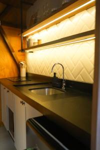 a kitchen with a sink and a counter top at Mauka Cabanas in Domingos Martins +4 photos