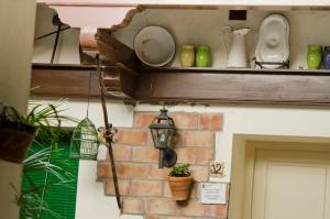 a shelf with dishes and a lamp on a building at Hostal Sixto in Rota +36 photos