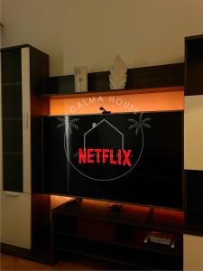 a tv screen with a netflix sign on it at Calma House in Caleta De Fuste +13 photos
