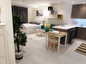 a kitchen and living room with a bed and a table at Amazing Studio in DAMAC in Amman