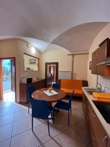 a kitchen and living room with a table and chairs at Apartma na Starem Placu in Idrija