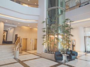 a lobby with potted plants on the wall at Breezbay Hotel Resort and Spa in Yokohama