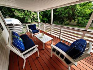 a deck with two chairs and a table on a porch at Pet friendly minutes to beach in Marlyn Manor