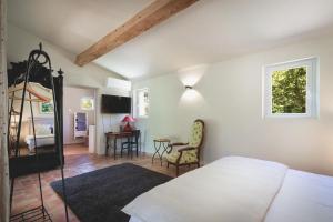 Postel nebo postele na pokoji v ubytování Bastide Sainte Trinide