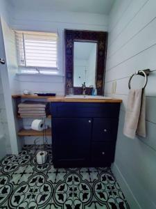a bathroom with a sink and a mirror at Pet friendly minutes to beach in Marlyn Manor