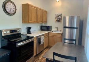 una cucina con armadi in legno e un orologio sul muro di Black House Mountain ATV Campground a Jamestown