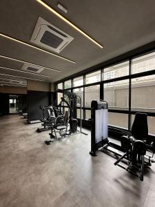 a gym with treadmills and chairs in a building at TrevizZo Is Consolação in Sao Paulo