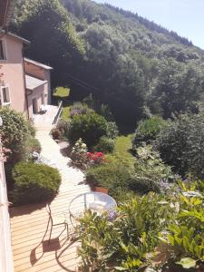 a wooden deck with a view of a mountain at La hautcsur la colline in Yzeron