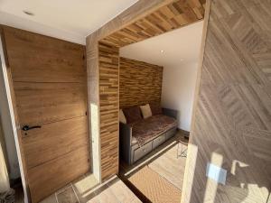 a room with a bed and a wooden wall at La Foux D'Allos Rez de jardin plein sud 50m des remontées mécaniques in La Foux