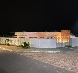 a building with a fence in front of it at night at Casa Mandaçaia in Piranhas