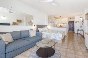a living room with a couch and a table at Costa Adeje Heated Pool Marina Primavera in Adeje