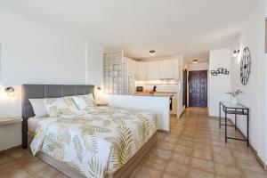 a bedroom with a bed and a kitchen at Costa Adeje Heated Pool Marina Primavera in Adeje +13 photos