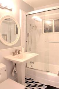 a white bathroom with a sink and a shower at Newly Furnished Pool House in Los Angeles